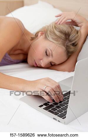 Young woman fallen asleep while on her laptop View Large Photo Image Stock Photograph - Young woman fallen asleep while on her laptop. Fotosearch