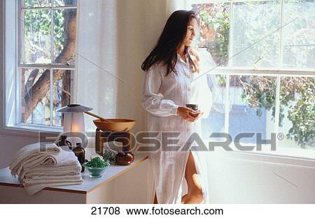 Young woman gazing out the window of her cozy room View Large Photo Image Stock Photo - Young woman gazing out the window of her cozy room. Fotosearch
