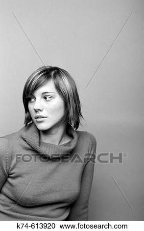 Stock Image - young woman gazing to the side. Fotosearch