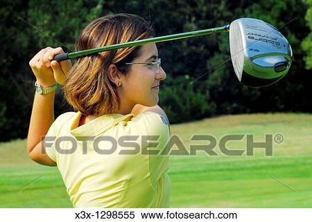 Young woman golfer at the end of the swing View Large Photo Image Stock Photography - Young woman golfer at the end of the swing. Fotosearch