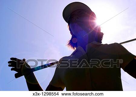 Young woman golfer observing terrain and conditions before hitting View Large Photo Image Picture - Young woman golfer observing terrain and conditions before hitting. Fotosearch