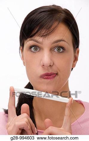 young woman grinning after using a self pregnancy test at home View Large Photo Image Stock Image - young woman grinning after using a self pregnancy test at home. Fotosearch