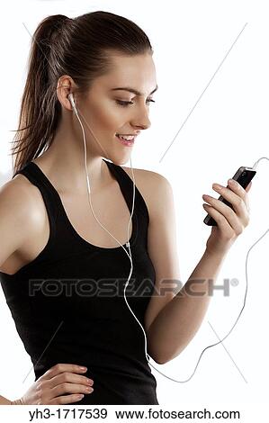 Young woman handholding a smartphone View Large Photo Image Stock Photo - Young woman handholding a smartphone. Fotosearch