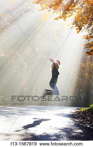 Young woman happy in Autumn View Large Photo Image Stock Photo - Young woman happy in Autumn. Fotosearch