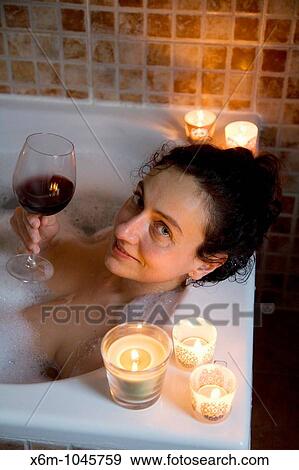 young woman having a bath with candles View Large Photo Image Stock Photo - young woman having a bath with candles. Fotosearch