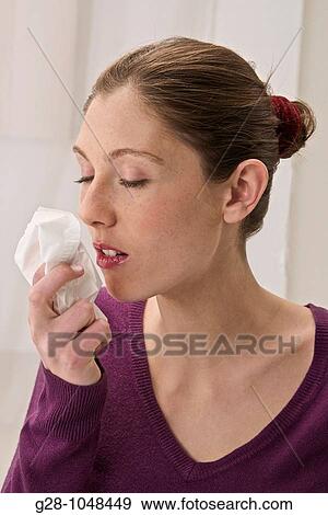 young woman having a cold with a handkerchief in her hand View Large Photo Image Stock Photo - young woman having a cold with a handkerchief in her hand. Fotosearch
