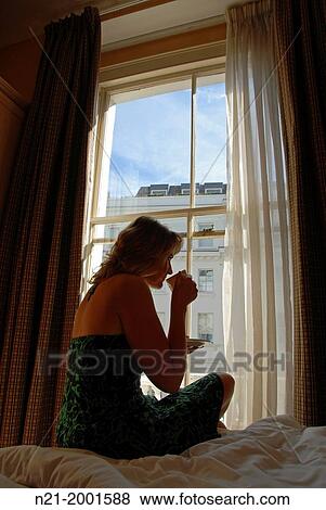 Young woman having a cup of coffee in the morning. London, Great Britain, Europe. View Large Photo Image Stock Photo - Young woman having a cup of coffee in the morning. London, Great Britain, Europe.. Fotosearch