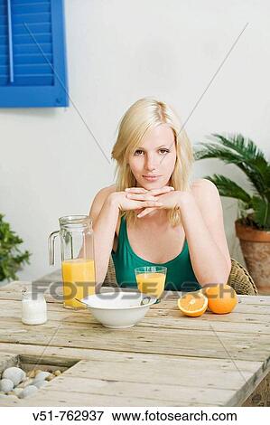 Young woman having a healthy breakfast View Large Photo Image Stock Photo - Young woman having a healthy breakfast. Fotosearch