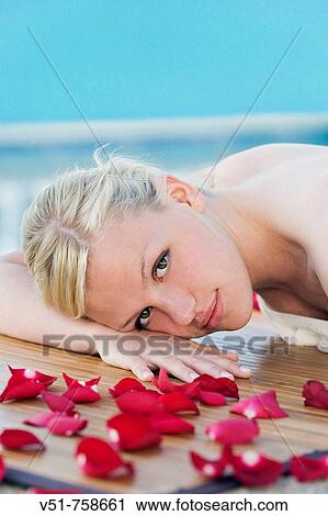 Young woman having a massage by the pool View Large Photo Image Stock Image - Young woman having a massage by the pool. Fotosearch