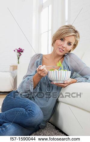 Young woman having a salad for lunch View Large Photo Image Picture - Young woman having a salad for lunch. Fotosearch
