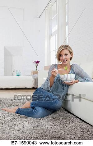 Young woman having a salad for lunch View Large Photo Image Stock Image - Young woman having a salad for lunch. Fotosearch