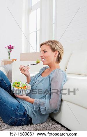 Young woman having a salad for lunch View Large Photo Image Stock Photo - Young woman having a salad for lunch. Fotosearch