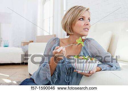 Young woman having a salad for lunch View Large Photo Image Stock Photograph - Young woman having a salad for lunch. Fotosearch