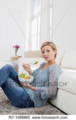 Young woman having a salad for lunch View Large Photo Image Stock Photography - Young woman having a salad for lunch. Fotosearch