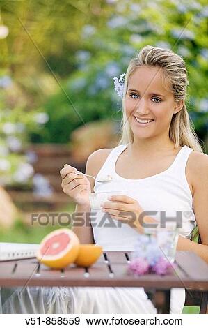 Young woman having breakfast View Large Photo Image Stock Photo - Young woman having breakfast. Fotosearch
