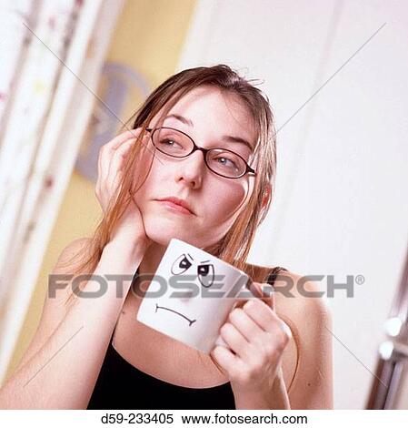 Stock Photography - Young woman having her first cup of coffee. Fotosearch