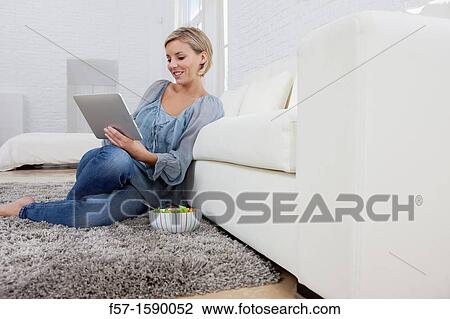 Young woman having lunch while socializing on her tablet computer View Large Photo Image Stock Image - Young woman having lunch while socializing on her tablet computer. Fotosearch