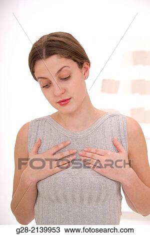 Stock Image - young woman her hans on her chest fro breathing problems asthma Angor. Fotosearch