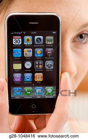 young woman hiding behind her telephone View Large Photo Image Stock Photograph - young woman hiding behind her telephone. Fotosearch