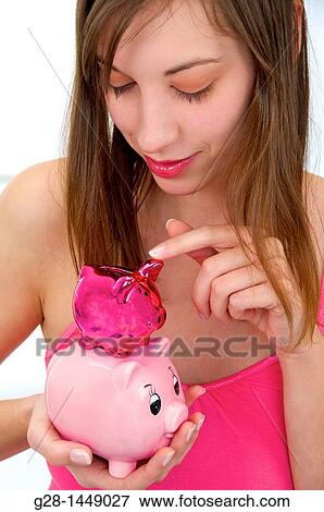 Young woman holding 2 brightly colored piggy money boxes View Large Photo Image Stock Photo - Young woman holding 2 brightly colored piggy money boxes. Fotosearch