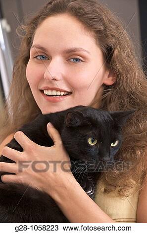 young woman holding a black cat, risk of allergy View Large Photo Image Stock Image - young woman holding a black cat, risk of allergy. Fotosearch