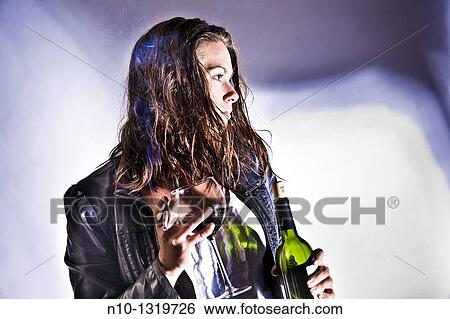 Young woman holding a bottle and glass of wine, and a cigarette View Large Photo Image Stock Photograph - Young woman holding a bottle and glass of wine, and a cigarette. Fotosearch