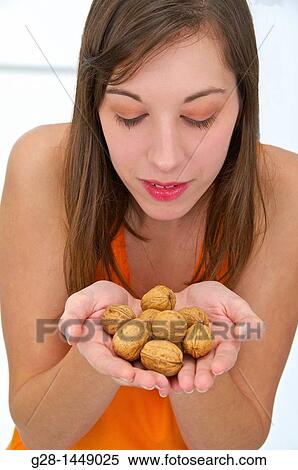 Young woman holding a handful of nuts View Large Photo Image Stock Photography - Young woman holding a handful of nuts. Fotosearch