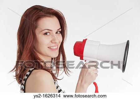 Young woman holding a megaphone View Large Photo Image Picture - Young woman holding a megaphone. Fotosearch