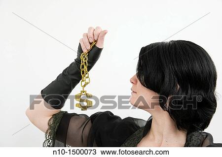 Young woman holding a necklace with an American dollar sign attached View Large Photo Image Stock Image - Young woman holding a necklace with an American dollar sign attached. Fotosearch