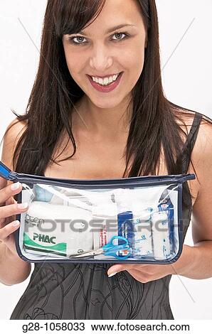 young woman holding a transparent first aid kit View Large Photo Image Stock Image - young woman holding a transparent first aid kit. Fotosearch