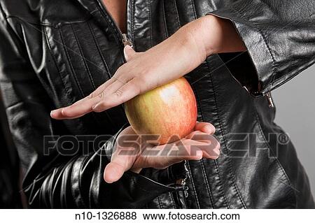 Young woman holding an apple View Large Photo Image Stock Photo - Young woman holding an apple. Fotosearch