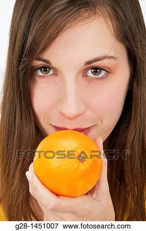 young woman holding an orange View Large Photo Image Stock Photo - young woman holding an orange. Fotosearch