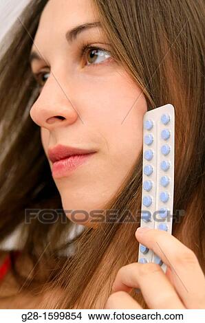 Young woman holding contraceptive pills View Large Photo Image Picture - Young woman holding contraceptive pills. Fotosearch