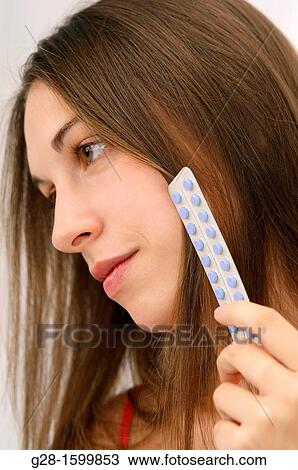 Young woman holding contraceptive pills View Large Photo Image Stock Image - Young woman holding contraceptive pills. Fotosearch