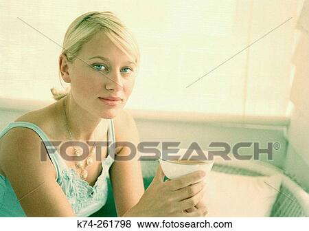 Young woman holding cup of tea View Large Photo Image Stock Photo - Young woman holding cup of tea. Fotosearch
