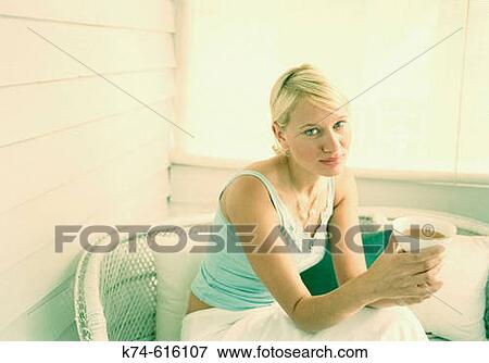 Stock Photo - Young woman holding cup of tea. Fotosearch