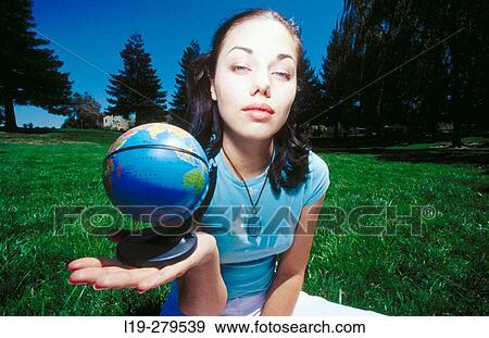 young woman holding globe View Large Photo Image Stock Photo - young woman holding globe. Fotosearch