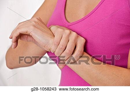 young woman holding her wrist suffering from twisted wrist or rheumatism ( head invisible ) View Large Photo Image Stock Image - young woman holding her wrist suffering from twisted wrist or rheumatism ( head invisible ). Fotosearch