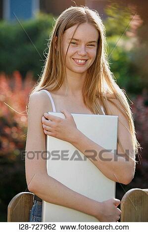 young woman holding laptop outdoors, laughing, portrait View Large Photo Image Stock Image - young woman holding laptop outdoors, laughing, portrait. Fotosearch