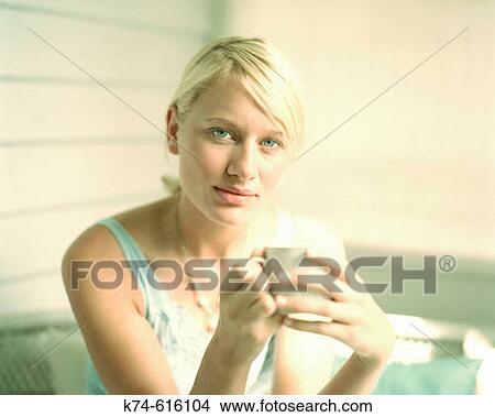 Young woman holding mug View Large Photo Image Picture - Young woman holding mug. Fotosearch