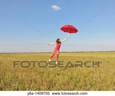 Young woman holding red umbrella View Large Photo Image Stock Photography - Young woman holding red umbrella. Fotosearch