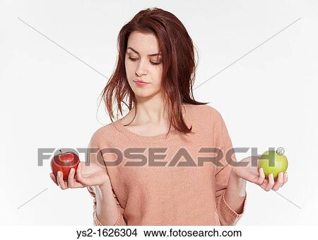 Young woman holding two apples View Large Photo Image Picture - Young woman holding two apples. Fotosearch