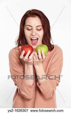 Young woman holding two apples View Large Photo Image Stock Photo - Young woman holding two apples. Fotosearch