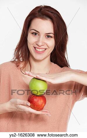 Young woman holding two apples View Large Photo Image Stock Photo - Young woman holding two apples. Fotosearch