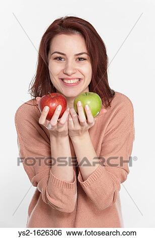 Young woman holding two apples View Large Photo Image Stock Photograph - Young woman holding two apples. Fotosearch