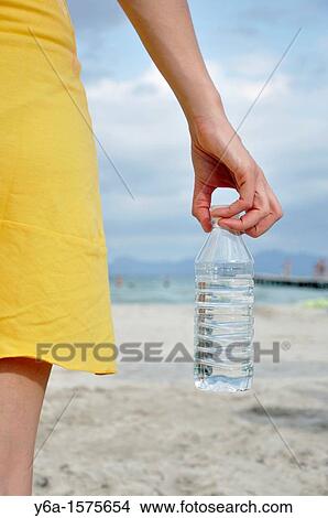 Young woman holding water bottle View Large Photo Image Picture - Young woman holding water bottle. Fotosearch