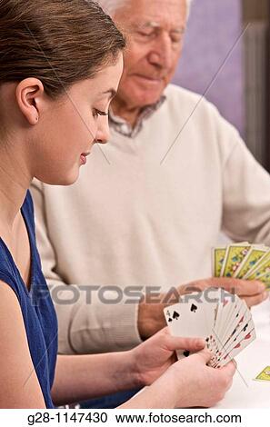 young woman, home help, or grand daughter playing card with senior man or grand father, for memory View Large Photo Image Stock Image - young woman, home help, or grand daughter playing card with senior man or grand father, for memory. Fotosearch