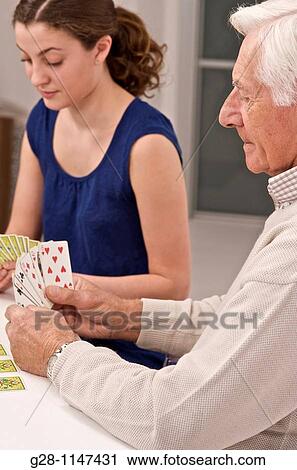 young woman, home help, or grand daughter playing card with senior man or grand father, for memory View Large Photo Image Stock Image - young woman, home help, or grand daughter playing card with senior man or grand father, for memory. Fotosearch