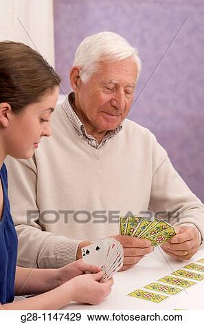 young woman, home help, or grand daughter playing card with senior man or grand father, for memory View Large Photo Image Stock Photo - young woman, home help, or grand daughter playing card with senior man or grand father, for memory. Fotosearch
