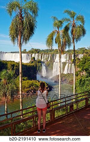 Young woman. Iguaz Falls. Iguaz National Park. Argentina/Brazil View Large Photo Image Stock Image - Young woman. Iguaz Falls. Iguaz National Park. Argentina/Brazil. Fotosearch